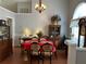 Traditional dining room with a warm chandelier, showcasing a classic china cabinet and hardwood floors at 3220 Town And Country Rd, Oviedo, FL 32766