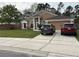 Charming single-story home featuring a manicured lawn and inviting facade, with a spacious driveway at 3220 Town And Country Rd, Oviedo, FL 32766