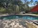 View of a private pool in a fenced yard with comfortable lounge seating at 3220 Town And Country Rd, Oviedo, FL 32766