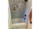 Tiled shower with built-in shelving and dark hardware at 3220 Town And Country Rd, Oviedo, FL 32766