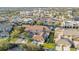 An aerial view of the house nestled in a vibrant neighborhood with nearby commercial buildings at 4038 Hunters Park Ln, Orlando, FL 32837