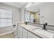 Modern bathroom with double sinks, a large mirror, and a walk-in shower featuring stylish tile work at 4038 Hunters Park Ln, Orlando, FL 32837