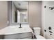 Modern bathroom with a grey vanity, white quartz countertop, and a shower featuring stylish white tile work at 4038 Hunters Park Ln, Orlando, FL 32837