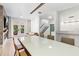 Open-concept dining area with modern lighting, a spacious table, and glass doors leading to the backyard at 4038 Hunters Park Ln, Orlando, FL 32837