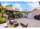 Private brick patio featuring outdoor seating, string lights, landscaping, and lush greenery at 4038 Hunters Park Ln, Orlando, FL 32837