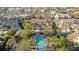 Aerial view of a stunning community pool with palm trees and nearby shopping at 4038 Hunters Park Ln, Orlando, FL 32837