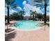 Relaxing community pool with lounge chairs surrounded by palm trees and blue skies at 4038 Hunters Park Ln, Orlando, FL 32837