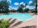 Community pool with clear water, a paved deck and lounge chairs for relaxation at 4038 Hunters Park Ln, Orlando, FL 32837