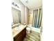 Bathroom showcasing a shower-tub combo, vanity sink, and light neutral colors at 4113 Golden Willow Cir, Apopka, FL 32712