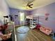 Charming bedroom featuring a loft bed, desk area, and a playful, colorful decor at 4113 Golden Willow Cir, Apopka, FL 32712