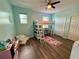 Cozy bedroom featuring a loft bed, hardwood floors, and natural light from the windows at 4113 Golden Willow Cir, Apopka, FL 32712