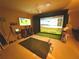 Unique game room with projector, simulation screen, and golf equipment at 4113 Golden Willow Cir, Apopka, FL 32712