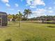 Expansive backyard with lush green lawn and mature landscaping overlooking a tranquil pond at 4119 Navigator Way, Kissimmee, FL 34746