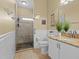 Bathroom featuring granite counters, white tile walls, and a tiled shower with glass doors at 4119 Navigator Way, Kissimmee, FL 34746