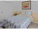 Bright bedroom with a leafy patterned bedspread, white walls, and closet at 4119 Navigator Way, Kissimmee, FL 34746