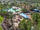 Aerial view of the community pool and recreation area with palm trees and lush landscaping at 4119 Navigator Way, Kissimmee, FL 34746