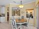 Charming dining area featuring a round table with gray chairs and an elegant hanging light fixture at 4119 Navigator Way, Kissimmee, FL 34746