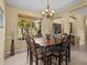 Formal dining room featuring a decorative chandelier and a beautiful view of the front yard at 4119 Navigator Way, Kissimmee, FL 34746