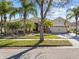 Stunning single Gathering home featuring well-manicured lawn, a paved driveway, and beautiful tropical landscaping at 4119 Navigator Way, Kissimmee, FL 34746