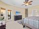 Main bedroom with a TV above a dresser and patio access provides indoor-outdoor living at 4119 Navigator Way, Kissimmee, FL 34746