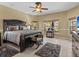 Well-appointed main bedroom with elegant furnishings and serene views from multiple windows at 4119 Navigator Way, Kissimmee, FL 34746