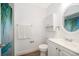 Bright bathroom features a shower with decorative curtain and white vanity at 4303 Tomlinson Cir, Orlando, FL 32829