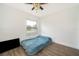 Bedroom featuring wood-look flooring, window, and ceiling fan at 4303 Tomlinson Cir, Orlando, FL 32829