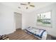 Bedroom featuring wood-look flooring, closet, and a large window at 4303 Tomlinson Cir, Orlando, FL 32829