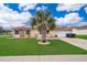 Charming single-story home with well-manicured lawn, palm tree, solar panels and attached garage at 4303 Tomlinson Cir, Orlando, FL 32829