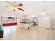 Open kitchen with white cabinetry, granite countertops, and a view into an adjacent sitting room at 4303 Tomlinson Cir, Orlando, FL 32829