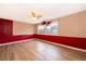 Living room with wood-look flooring and brightly painted accent wall at 4303 Tomlinson Cir, Orlando, FL 32829