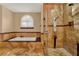 Bathroom featuring a walk-in shower with tile surround, soaking tub, and natural light at 4537 Woodlands Village Dr, Orlando, FL 32835