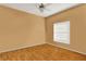 Bright bedroom with hardwood floors, ceiling fan, and natural light from a window at 4537 Woodlands Village Dr, Orlando, FL 32835