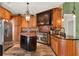 Gourmet kitchen featuring stainless steel appliances, custom cabinets, and granite countertops at 4537 Woodlands Village Dr, Orlando, FL 32835