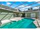 A refreshing pool is surrounded by a screened enclosure offering privacy at 4537 Woodlands Village Dr, Orlando, FL 32835