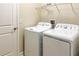 Convenient laundry room equipped with modern washer and dryer units, storage, and a door to exit at 4550 Tribute Trl, Kissimmee, FL 34746