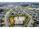 An aerial view displays the neighborhood, amenity center, playground, and community pool with lush landscaping at 4622 Fairy Tale Cir, Kissimmee, FL 34746
