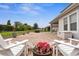 Brick-paved patio with Adirondack chairs and manicured lawn, perfect for relaxing and outdoor entertainment at 4622 Fairy Tale Cir, Kissimmee, FL 34746