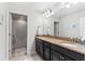 Bathroom featuring double vanity with granite counters, modern lighting, and a tub/shower combo in neutral tones at 4622 Fairy Tale Cir, Kissimmee, FL 34746