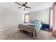 Bedroom with ceiling fan, carpet, and blue accents at 4622 Fairy Tale Cir, Kissimmee, FL 34746
