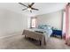 Bedroom with a ceiling fan, neutral carpet and walls, and dual nightstands at 4622 Fairy Tale Cir, Kissimmee, FL 34746