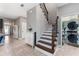 Inviting foyer with staircase and stylish tile flooring leads to a convenient laundry room at 4622 Fairy Tale Cir, Kissimmee, FL 34746