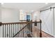 Second floor hallway featuring decorative wood and iron railing and access to multiple rooms at 4622 Fairy Tale Cir, Kissimmee, FL 34746