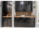 Kitchen area featuring dark wood cabinets and granite countertops with tiled backsplash at 4622 Fairy Tale Cir, Kissimmee, FL 34746