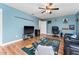 Living room with hardwood floors, ceiling fan, and blue walls at 4622 Fairy Tale Cir, Kissimmee, FL 34746