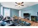 Living room with hardwood floors, ceiling fan, and blue walls at 4622 Fairy Tale Cir, Kissimmee, FL 34746