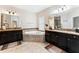 A luxurious main bathroom features double sinks, granite countertops, a soaking tub, and tile flooring at 4622 Fairy Tale Cir, Kissimmee, FL 34746