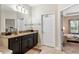 Spacious primary bathroom featuring granite countertop and adjoining bedroom at 4622 Fairy Tale Cir, Kissimmee, FL 34746