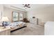 The main bedroom has a ceiling fan, tray ceiling, windows, and an updated dresser at 4622 Fairy Tale Cir, Kissimmee, FL 34746