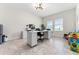 Bright home office with white furniture, natural light, and tile flooring at 4622 Fairy Tale Cir, Kissimmee, FL 34746